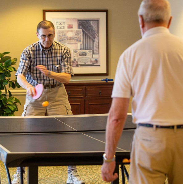 Two residents playing ping pong.