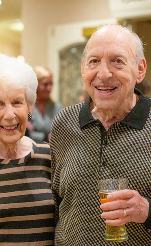 Resident couple with drinks at an event.