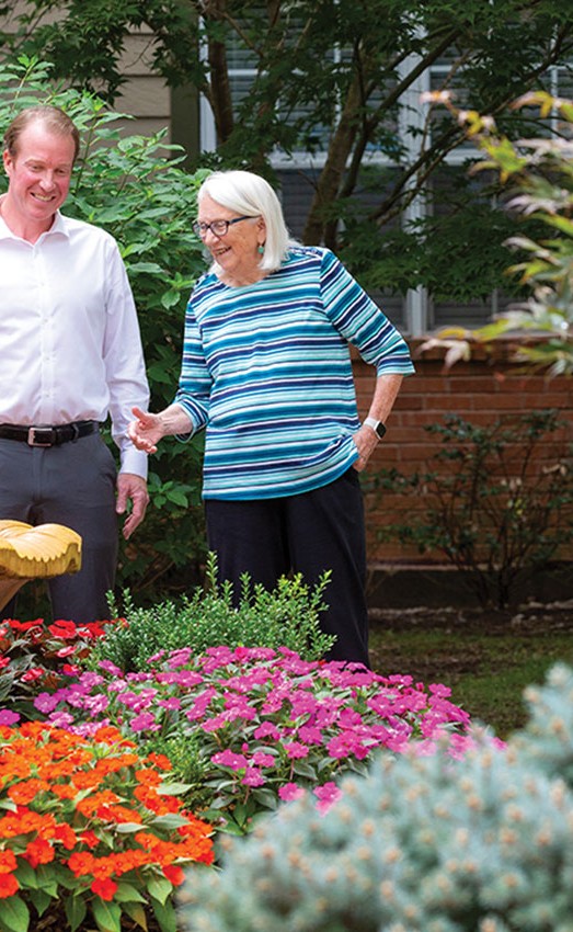 Chris Leonard with Resident in Outdoor Garden