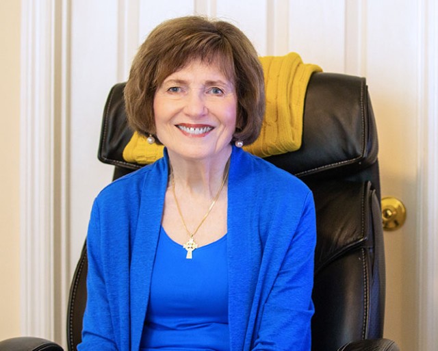 A resident seated with her computer.