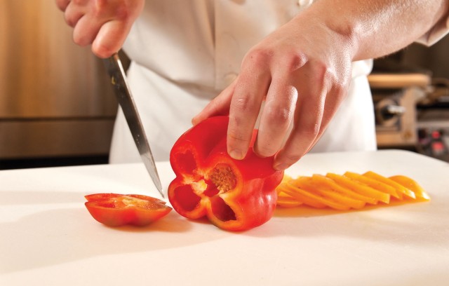 Chef chopping red bell pepper