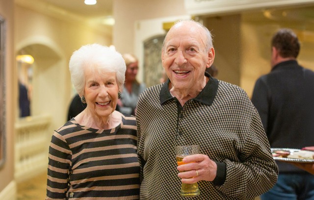 Resident couple with drinks at an event.