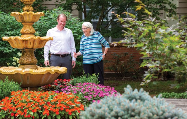 Chris Leonard with Resident in Outdoor Garden