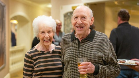 Resident couple with drinks at an event.