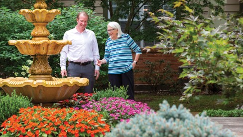 Chris Leonard with Resident in Outdoor Garden